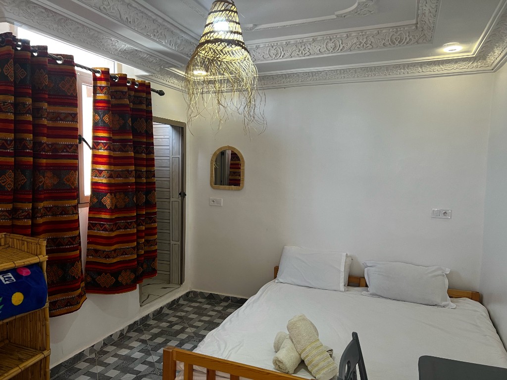 Studio room with berber curtains and kitchenette